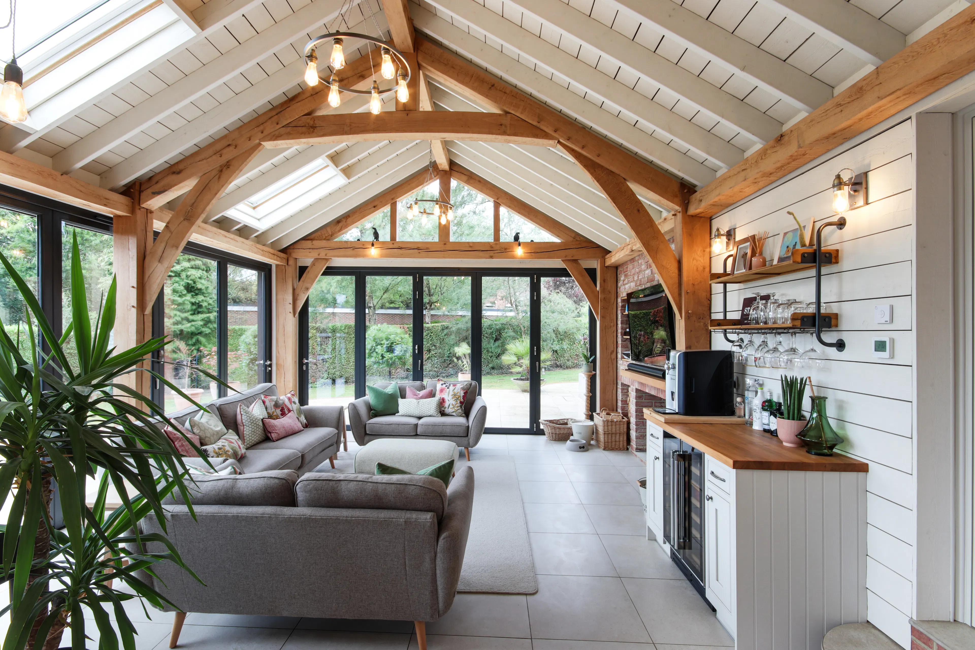 A modern oak framed extension family room with integrated glazing and roof lights providing lots of natural light.