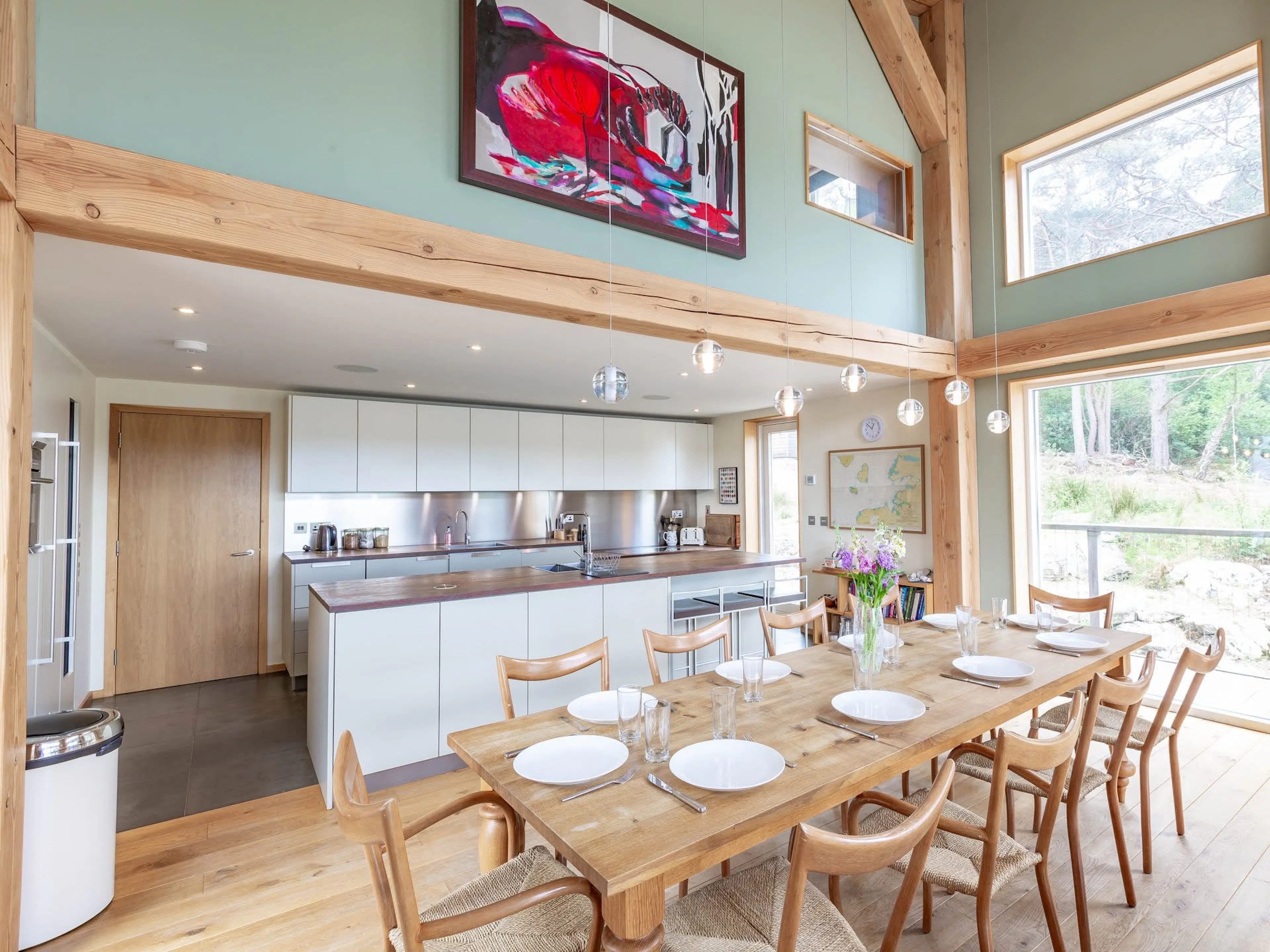 Interior view of a Douglas fir framed house with an open dining area and kitchen