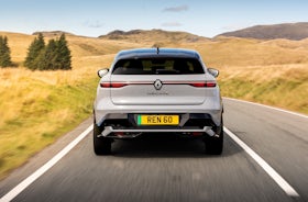 White Renault Megane Etech Electric driving rear view.