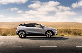 White Renault Megane Etech Electric parked side view.