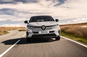 White Renault Megane Etech Electric driving front view