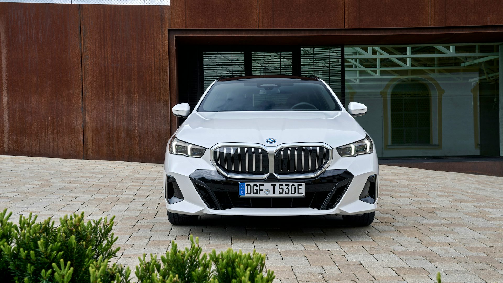 White 2024 BMW 5 Series Touring parked, front.