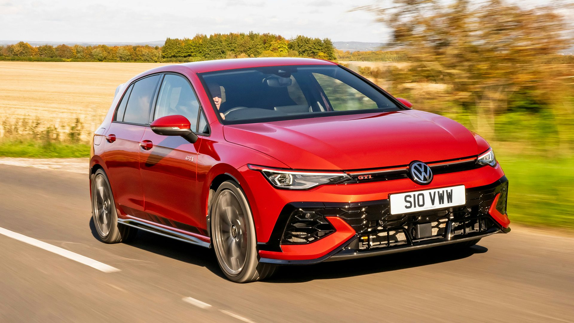 2025 Volkswagen Golf GTI CS, RHD, red, exterior front three quarter view driving