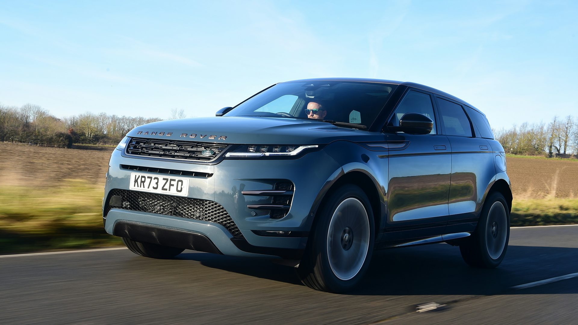 2025 Land Rover Range Rover Evoque, RHD, blue, exterior front three quarter view driving