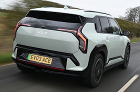 2025 Kia EV3 RHD green exterior rear three quarter view driving