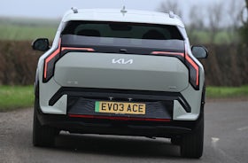 2025 Kia EV3 RHD green exterior rear view driving