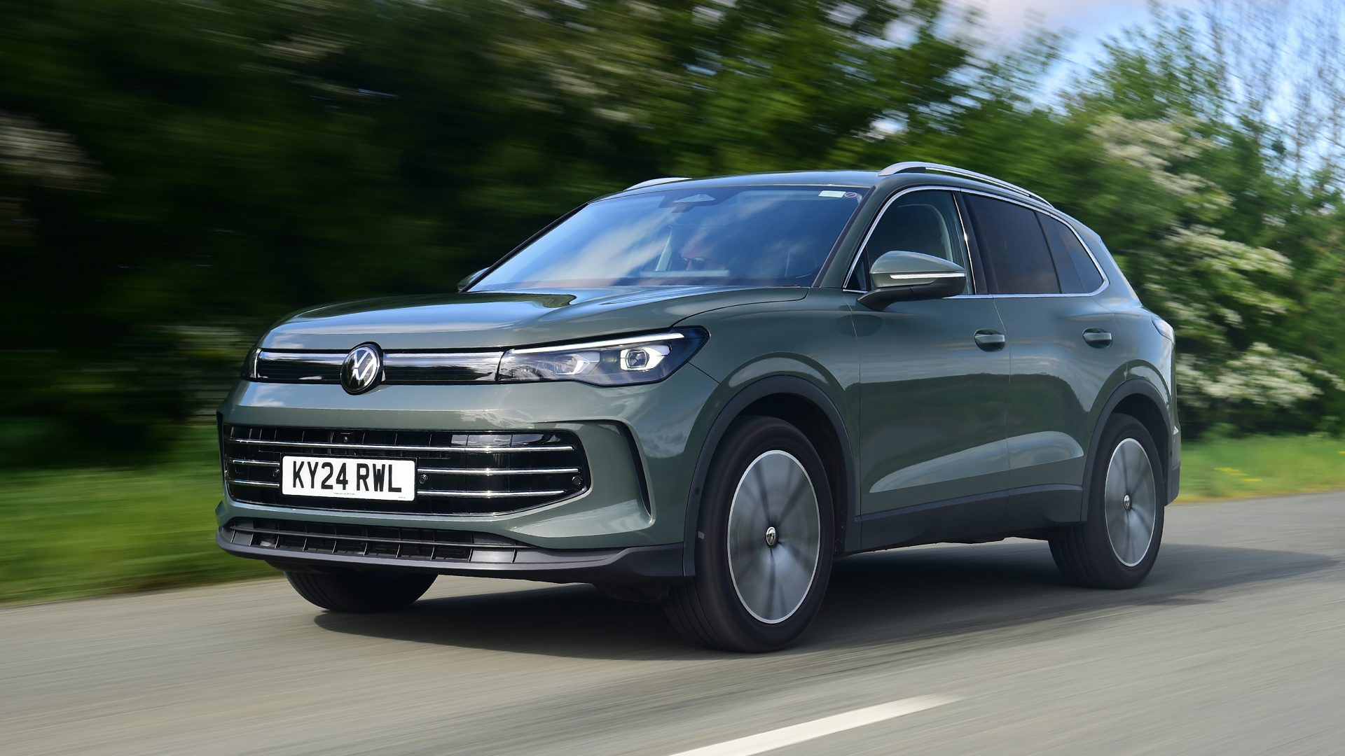 2025 Volkswagen Tiguan RHD green exterior front three quarter view driving