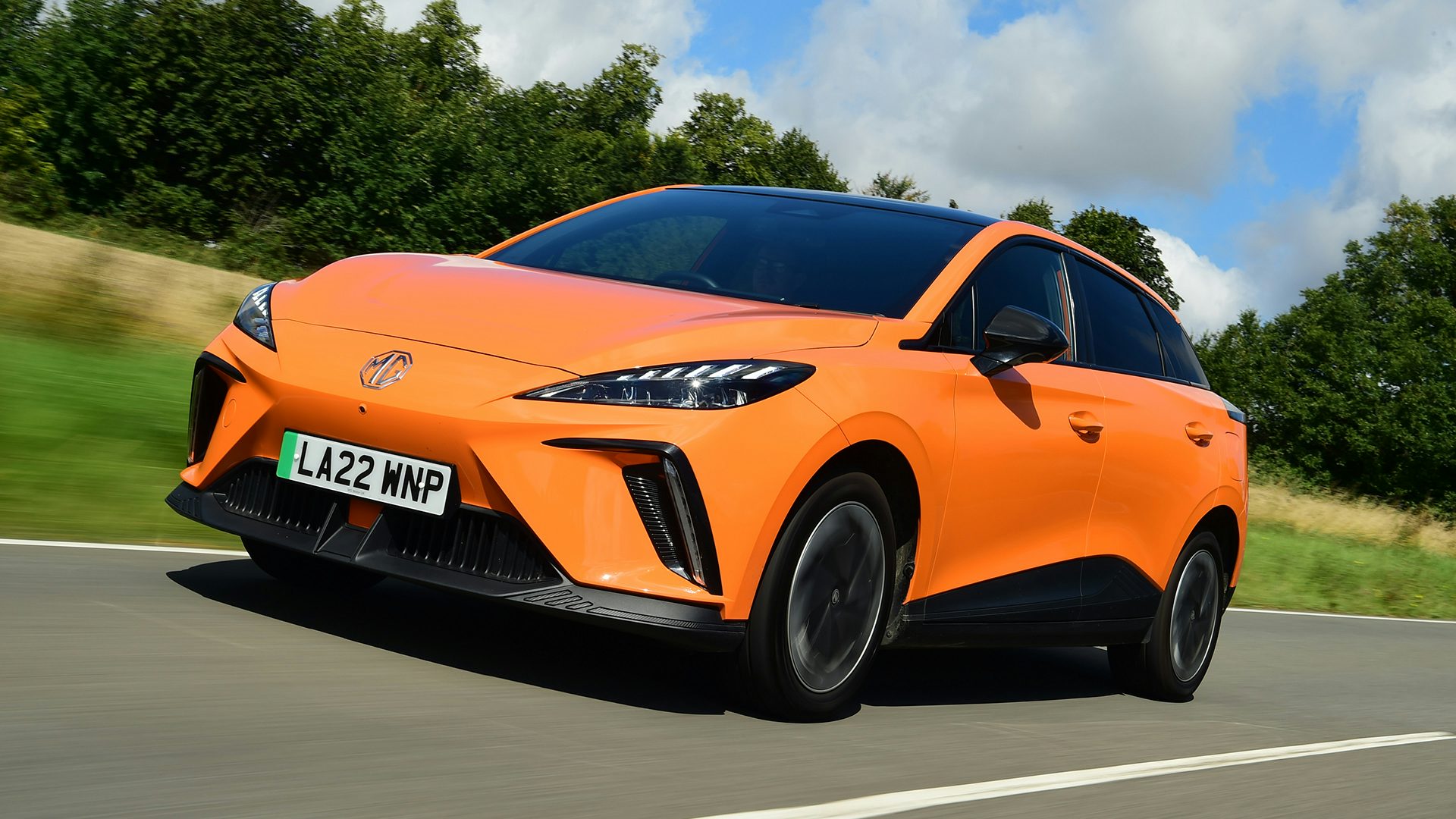 2025 MG4 RHD orange exterior front three quarter view driving