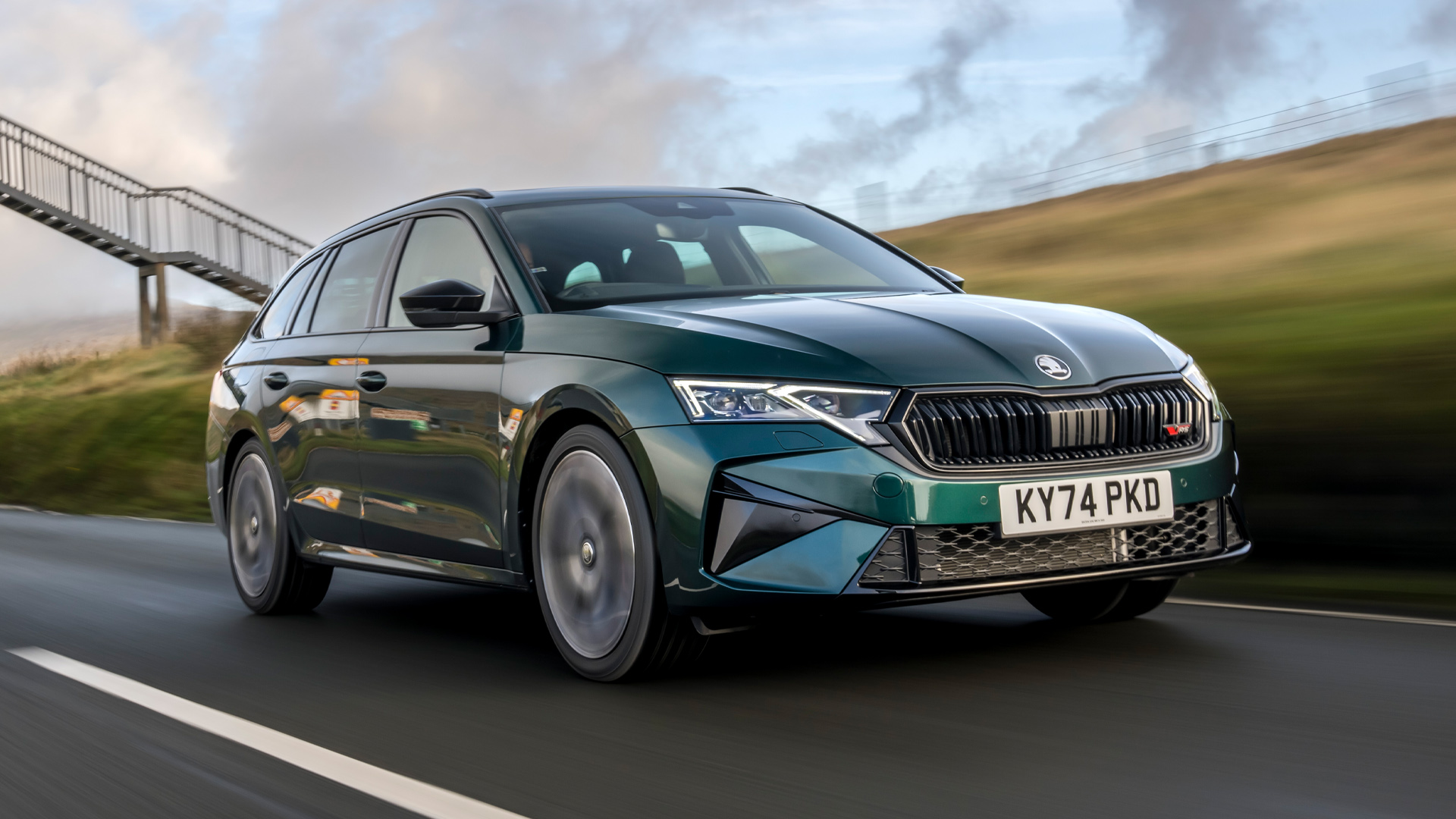 Green 2026 Skoda Octavia vRS Estate RHD driving on a country road