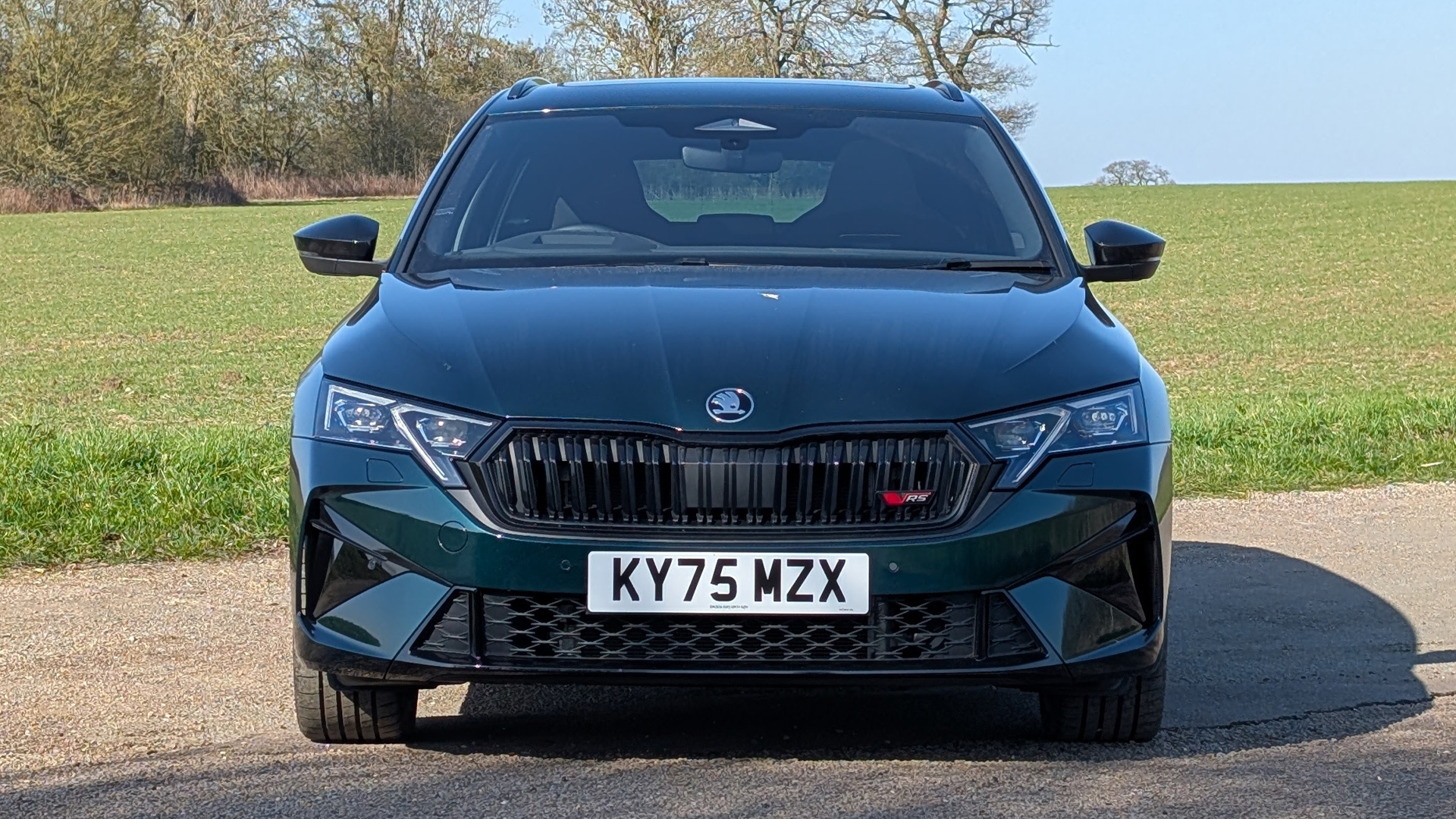 Green 2026 RHD Skoda Octavia vRS Estate parked in front of a field
