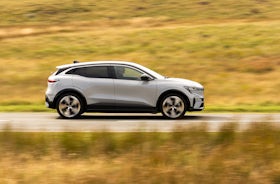 White Renault Megane Etech Electric driving side view.