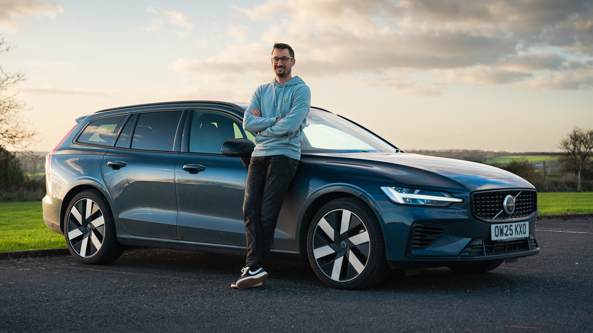 Darren Cassey standing with his long-term Volvo V60.