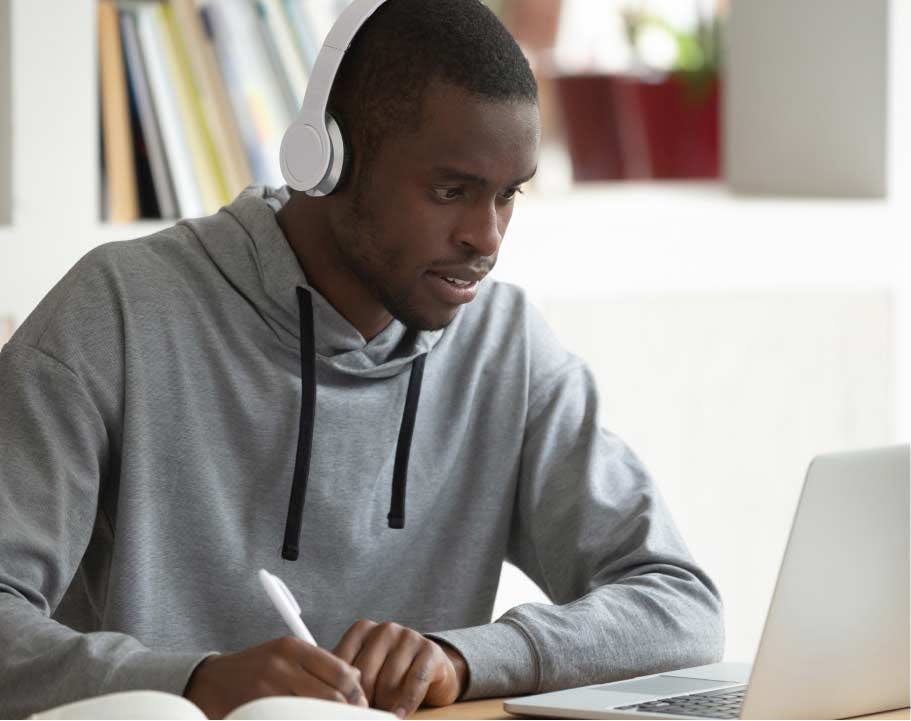 Male student working at his own pace on computer