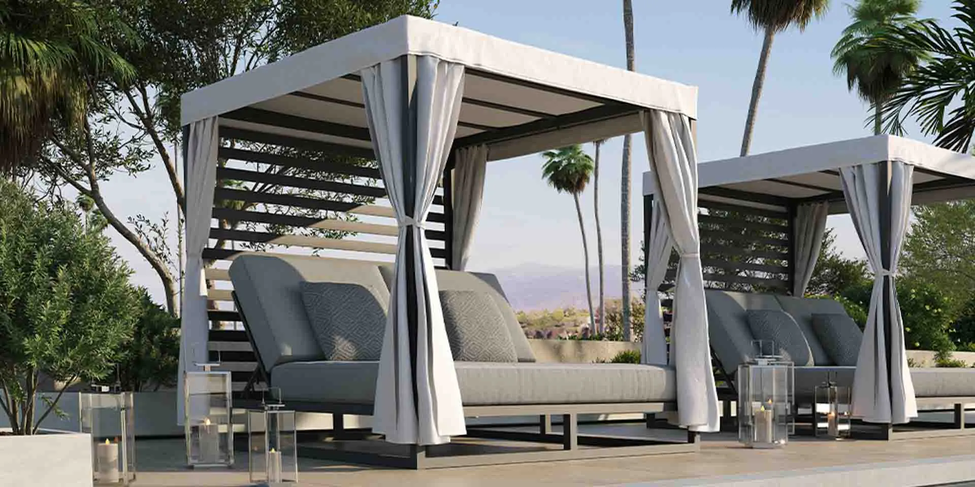 Patio furniture in poolside setting with palm trees.