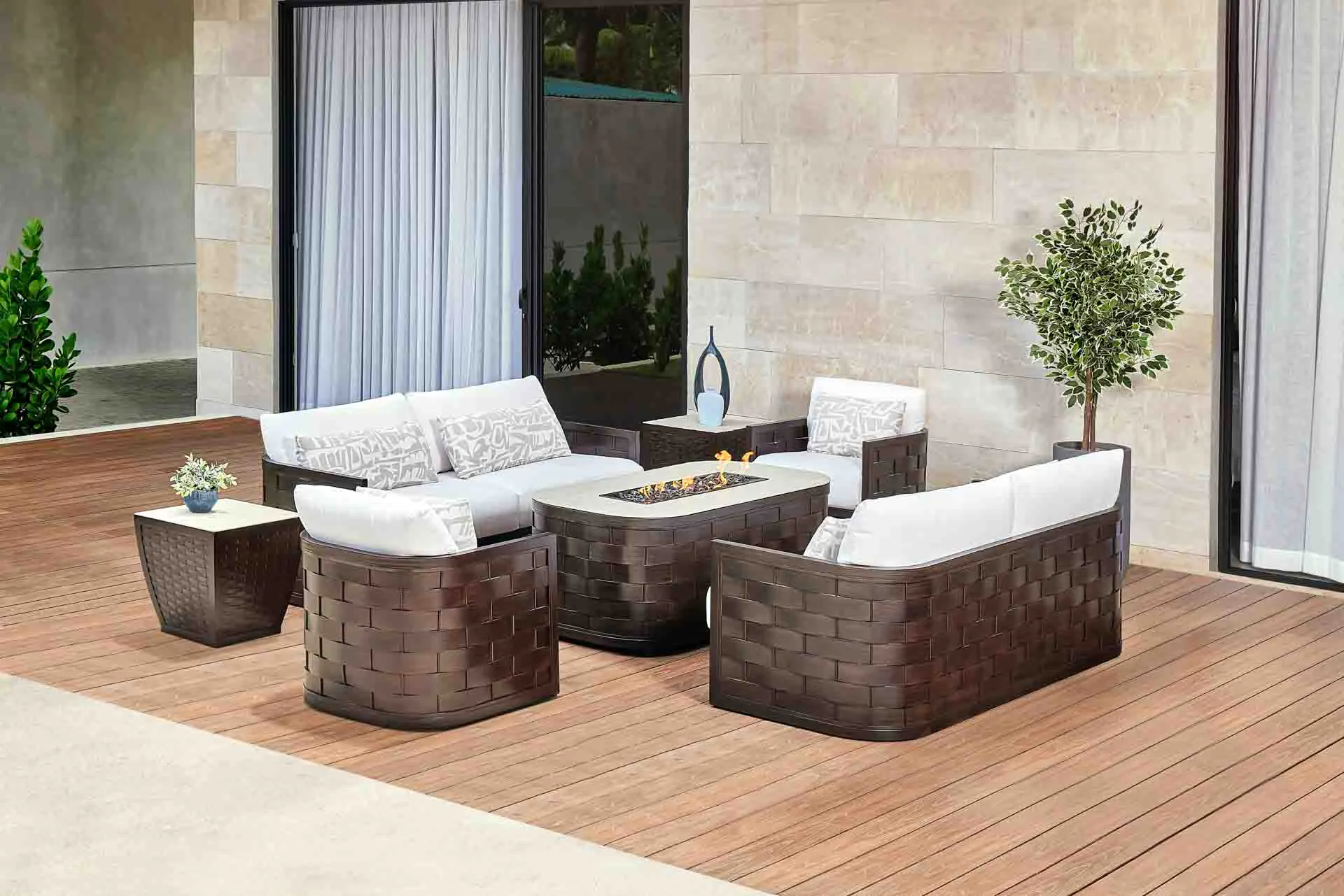 Outdoor patio setting with lounge seating, end tables, and fire table.