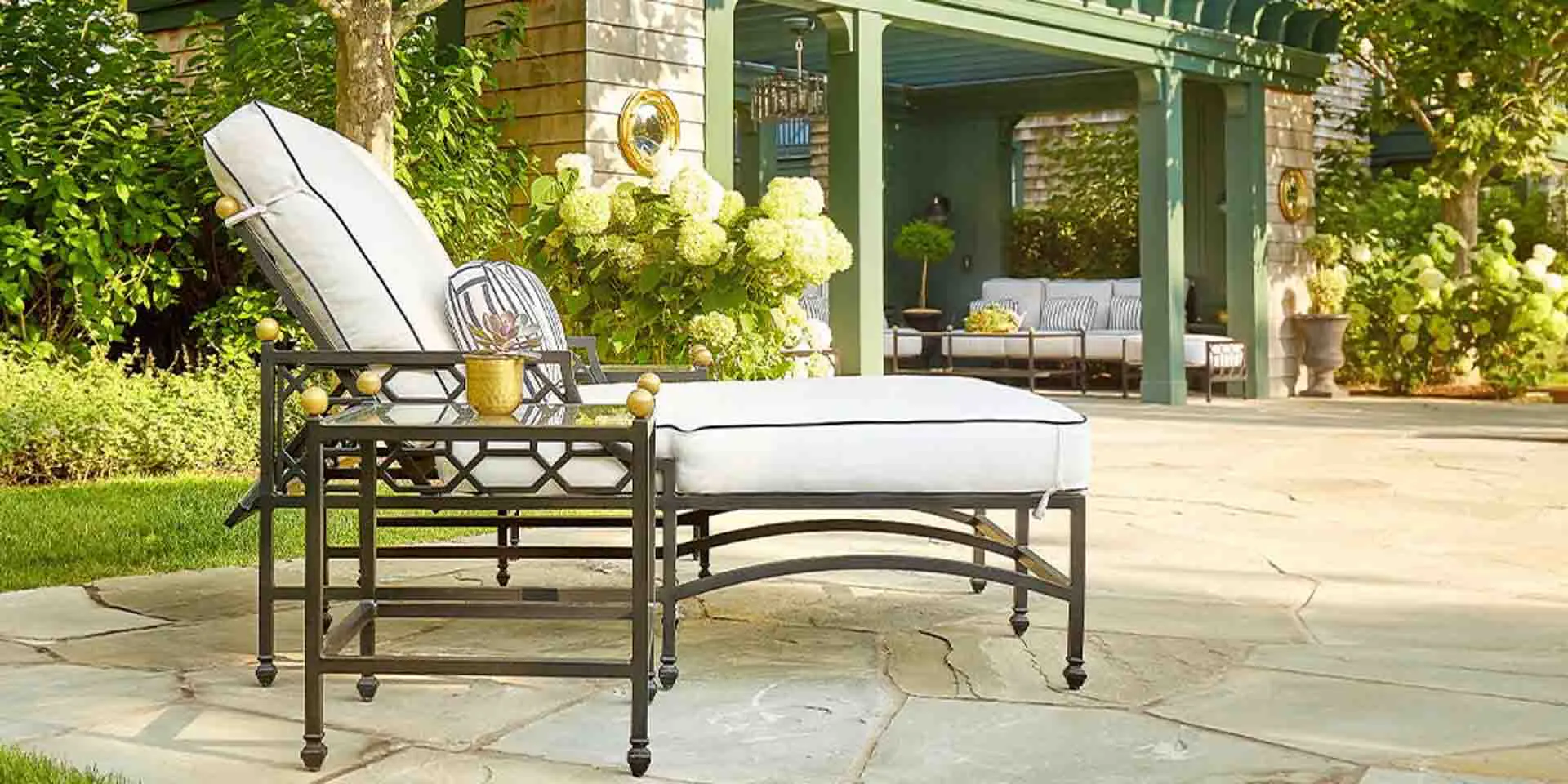 Lounge furniture in garden poolside setting.