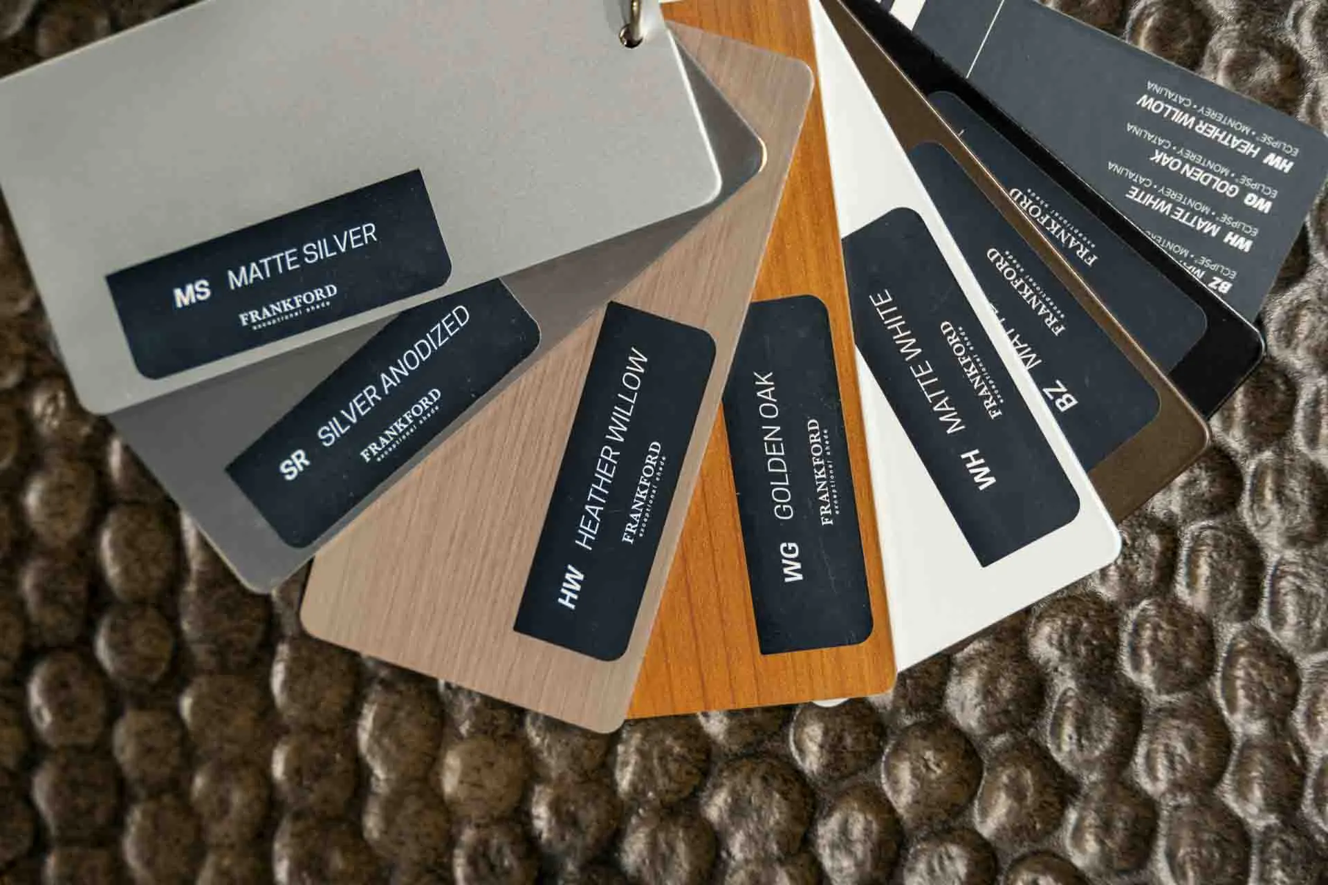 Assortment of outdoor furniture swatches laid out on tabletop.