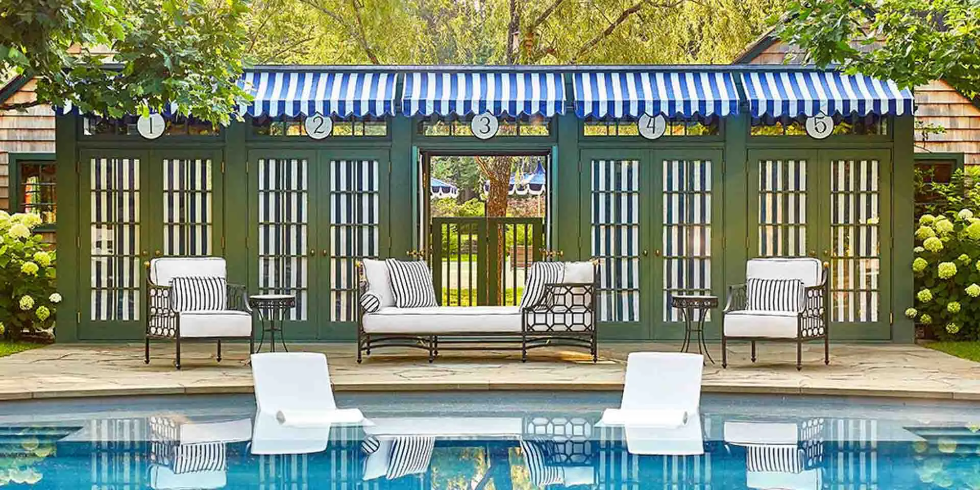 Stylish poolside Barclay Butera Signature Collection in luxury setting.