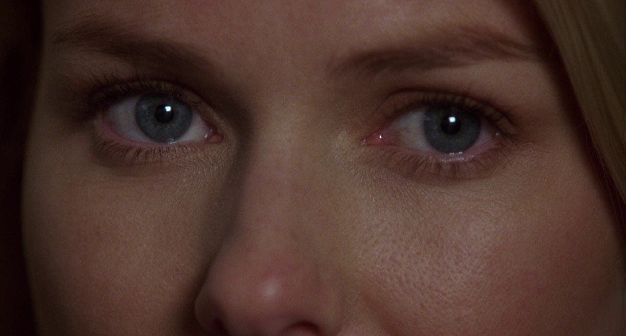 A close-up of a woman's captivating blue eyes.