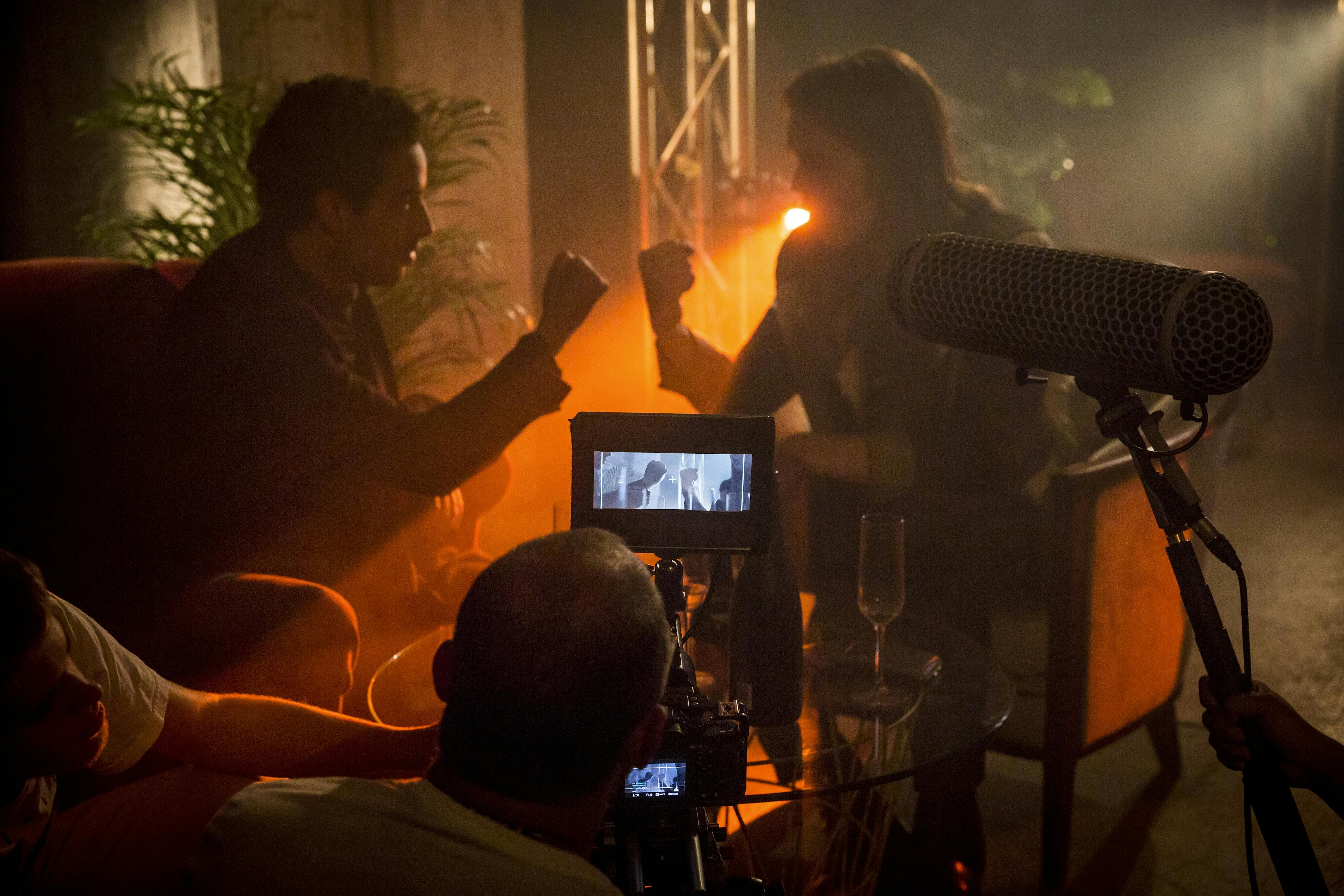 Two actors on set, infront of them is two camera operators and someone holding a mic