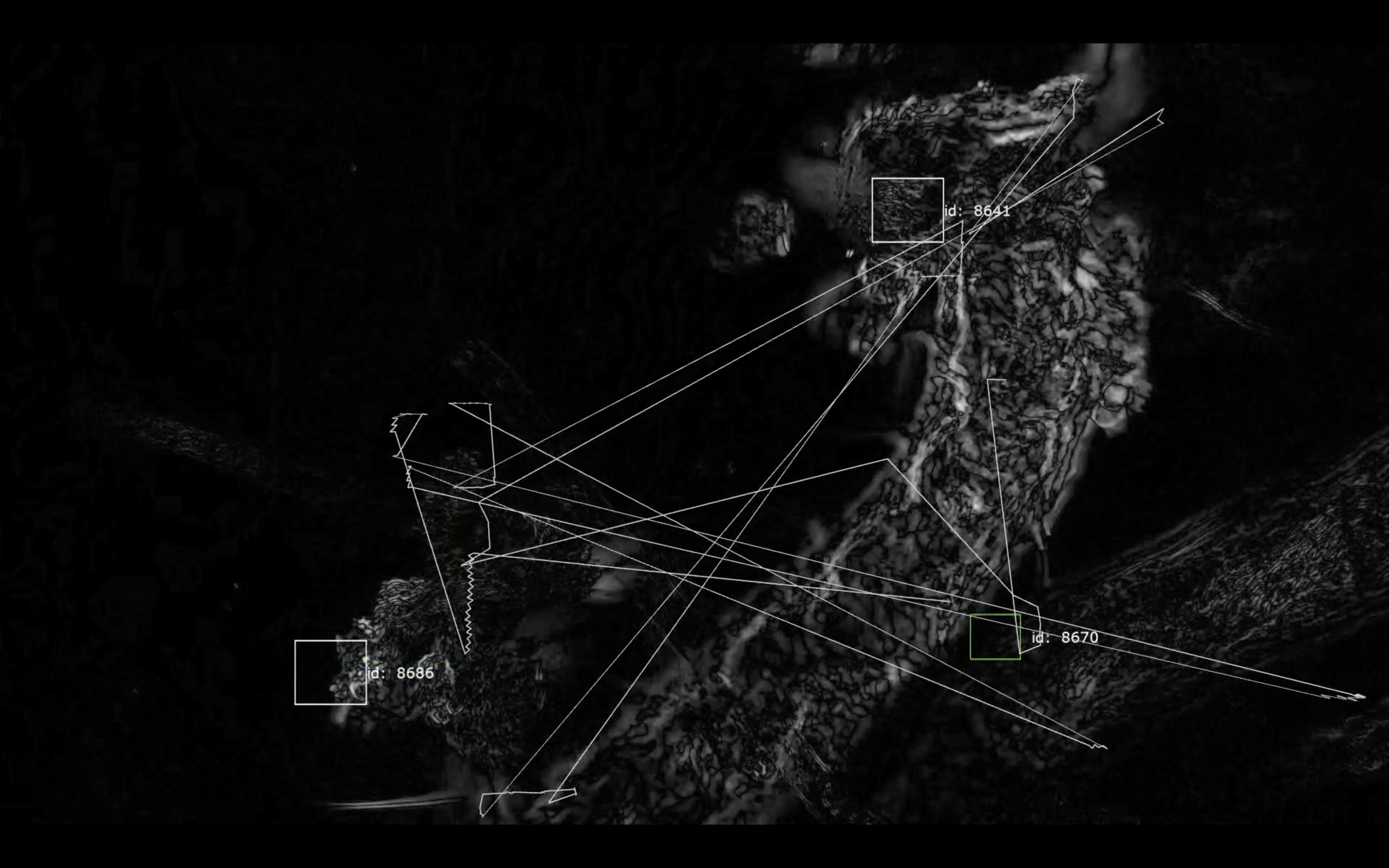 A monochrome image of bacteria under a microscope with software identifying parts of it the image