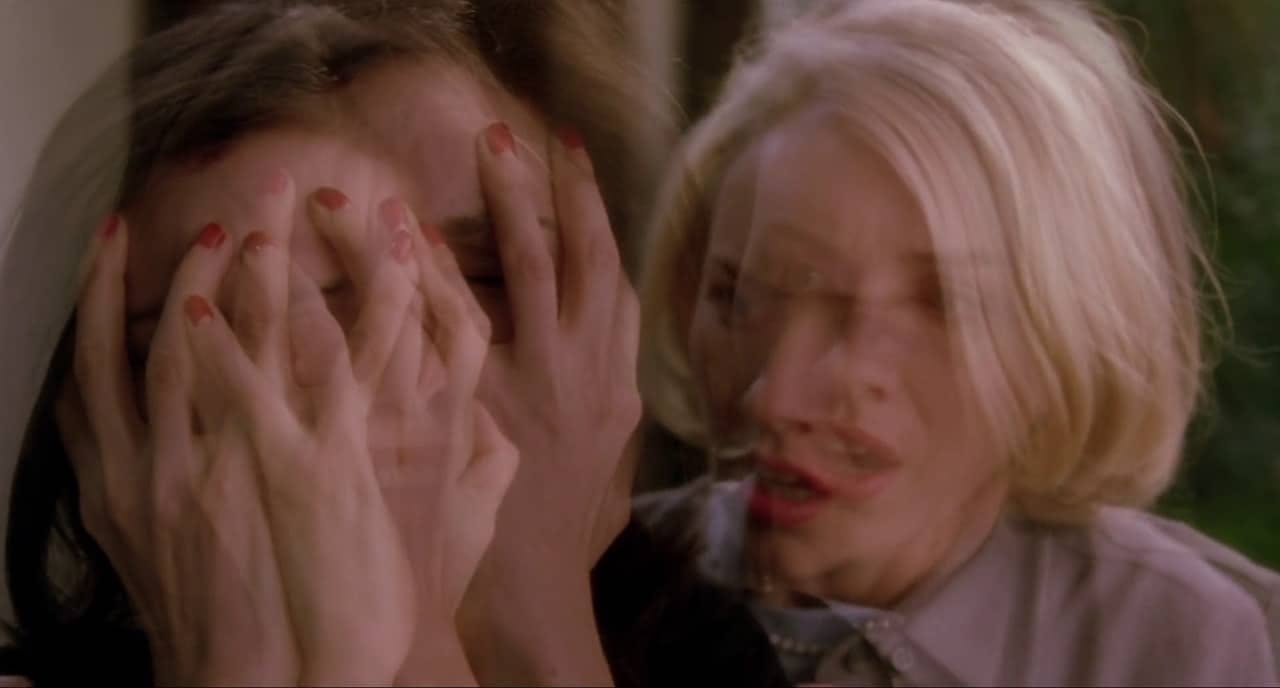 Two women covering their faces with their hands in a gesture of surprise.