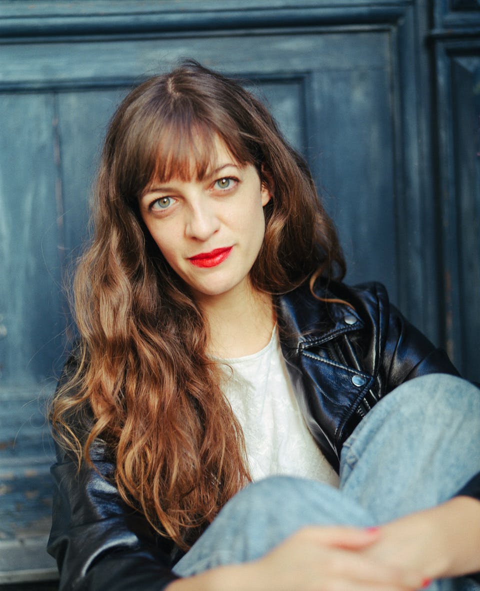 MSVM tutor Aude Langlois sits infront of a door. Photo by Vera Landmann