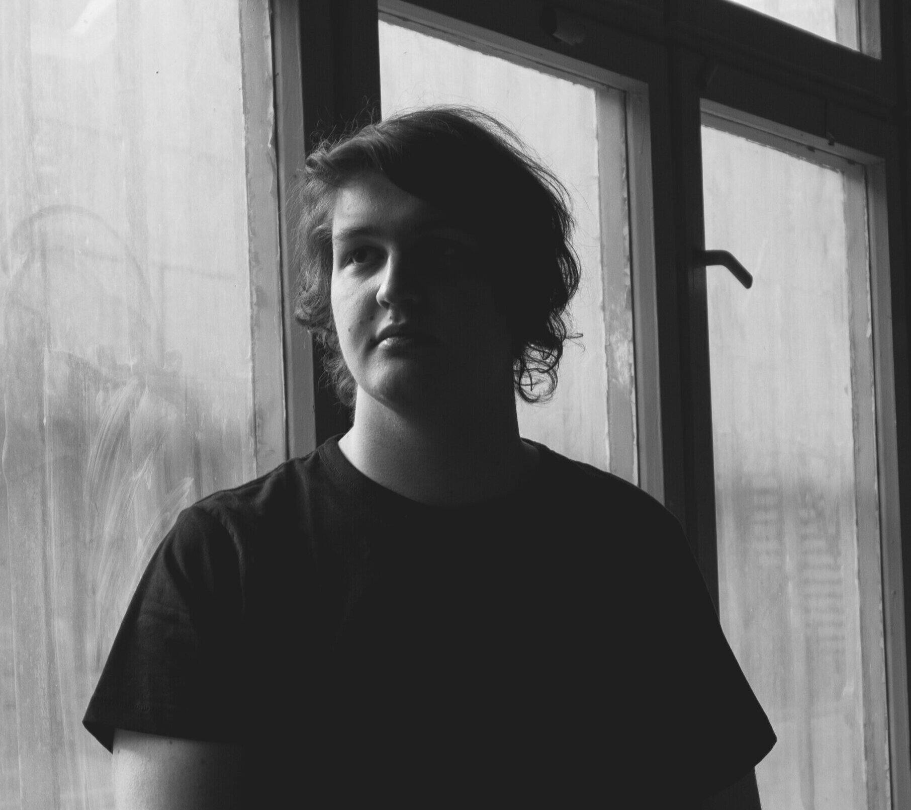 MSVM tutor Felipe Vareschi infront of a windowing, looking to the left of the shot in black and white