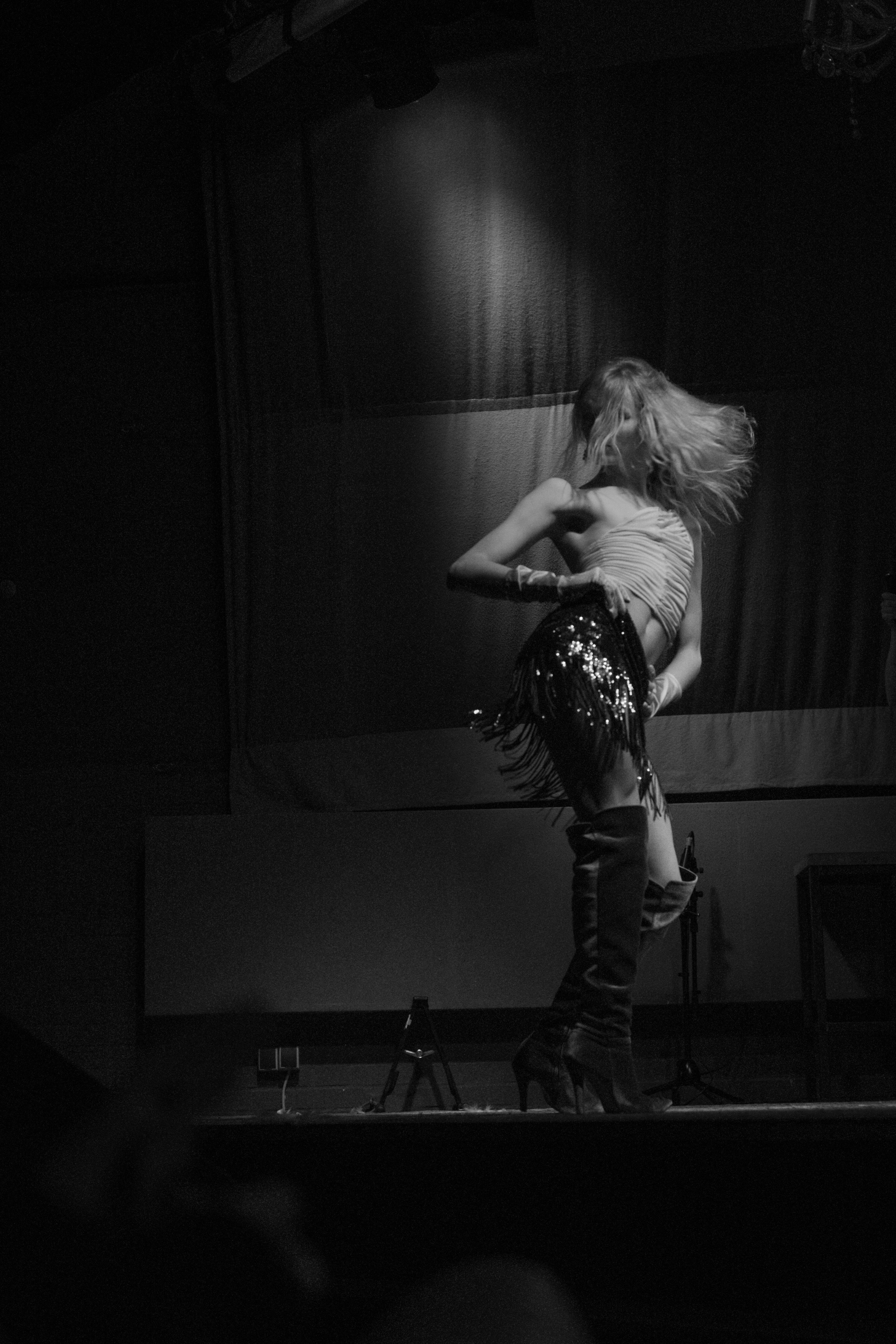 Rhys Williams shakes her hips on stage in heeled boots