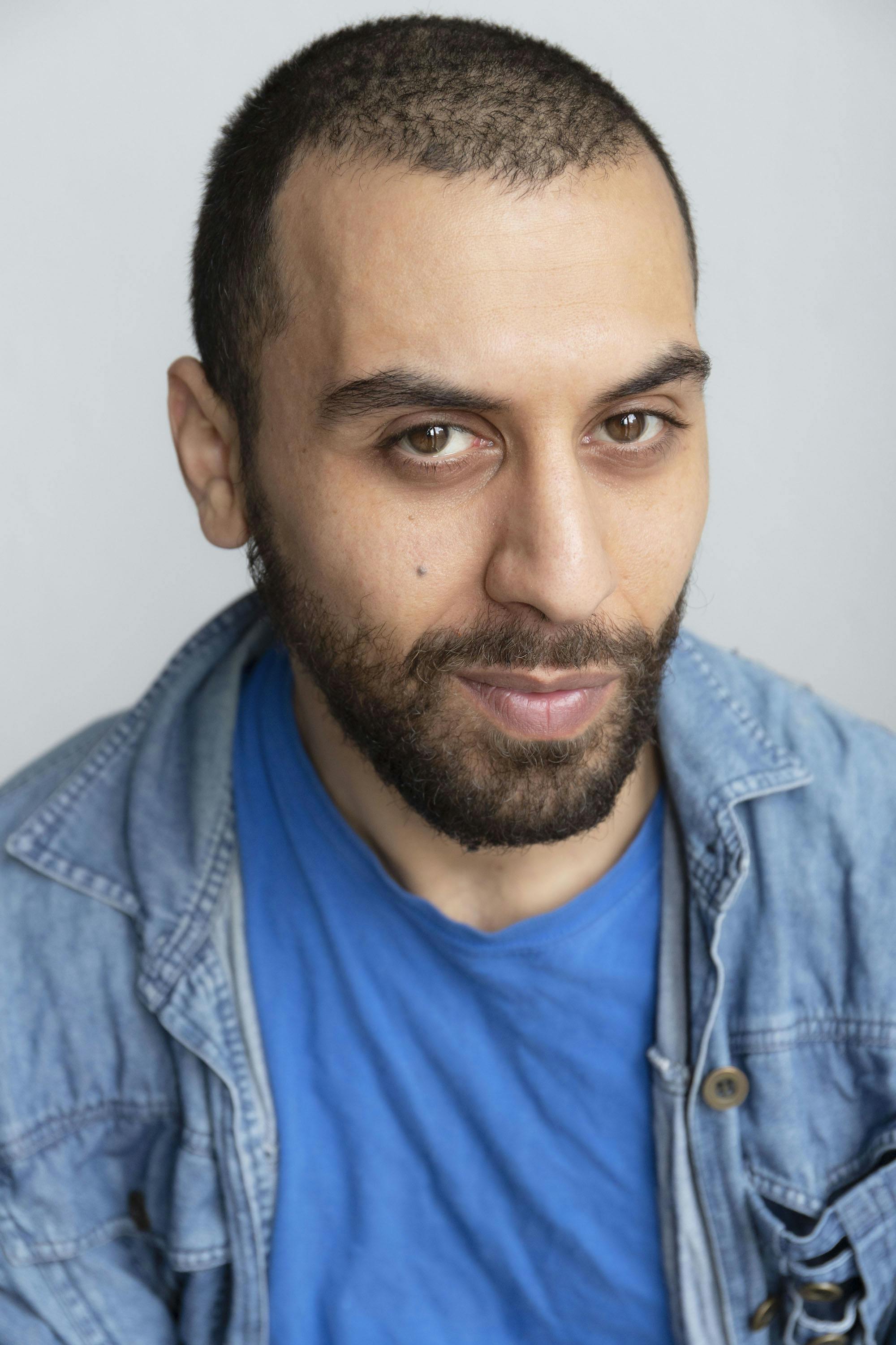 screen acting graduate Ammar smiles into the camera