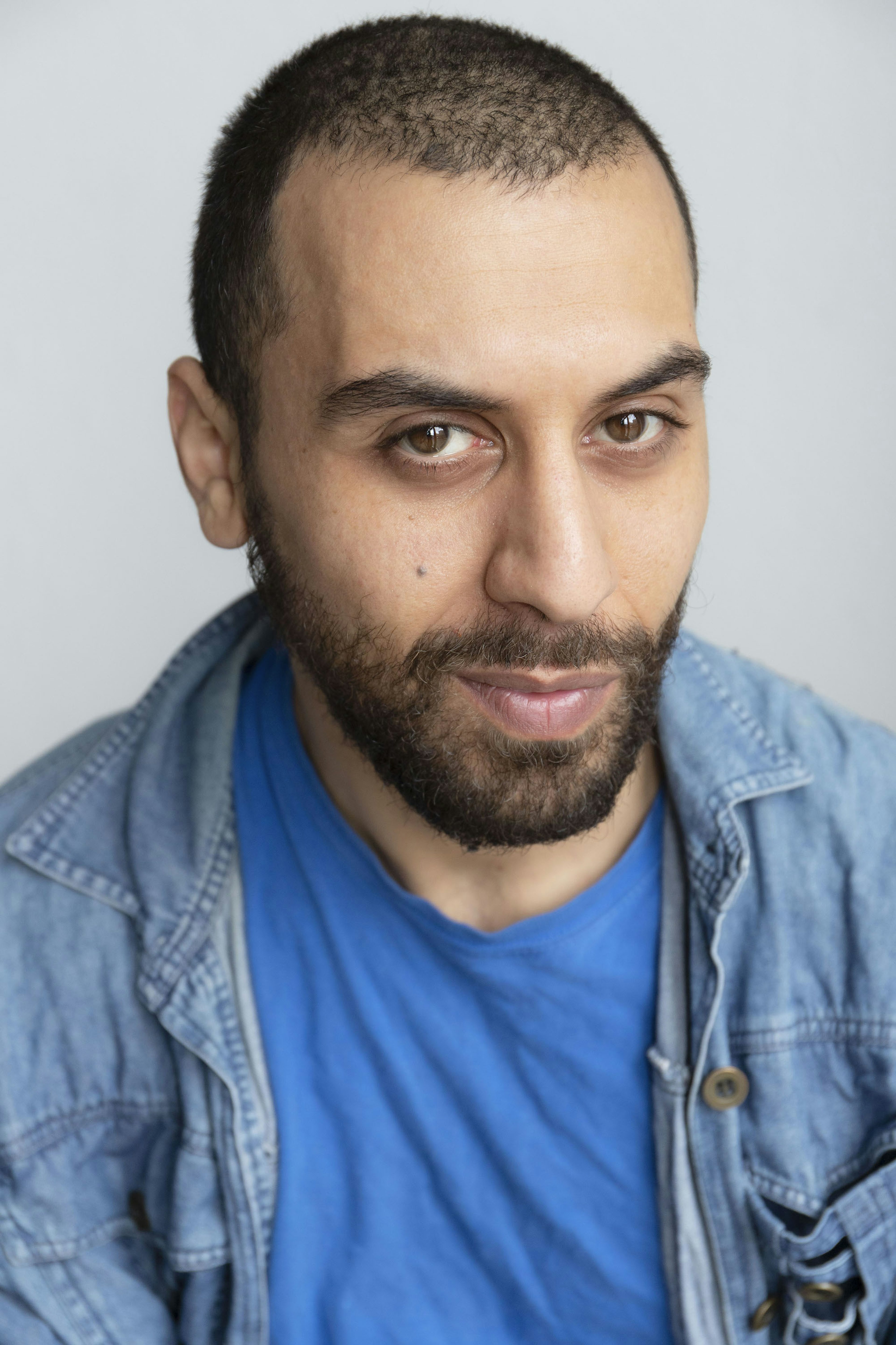 screen acting graduate Ammar smiles into the camera