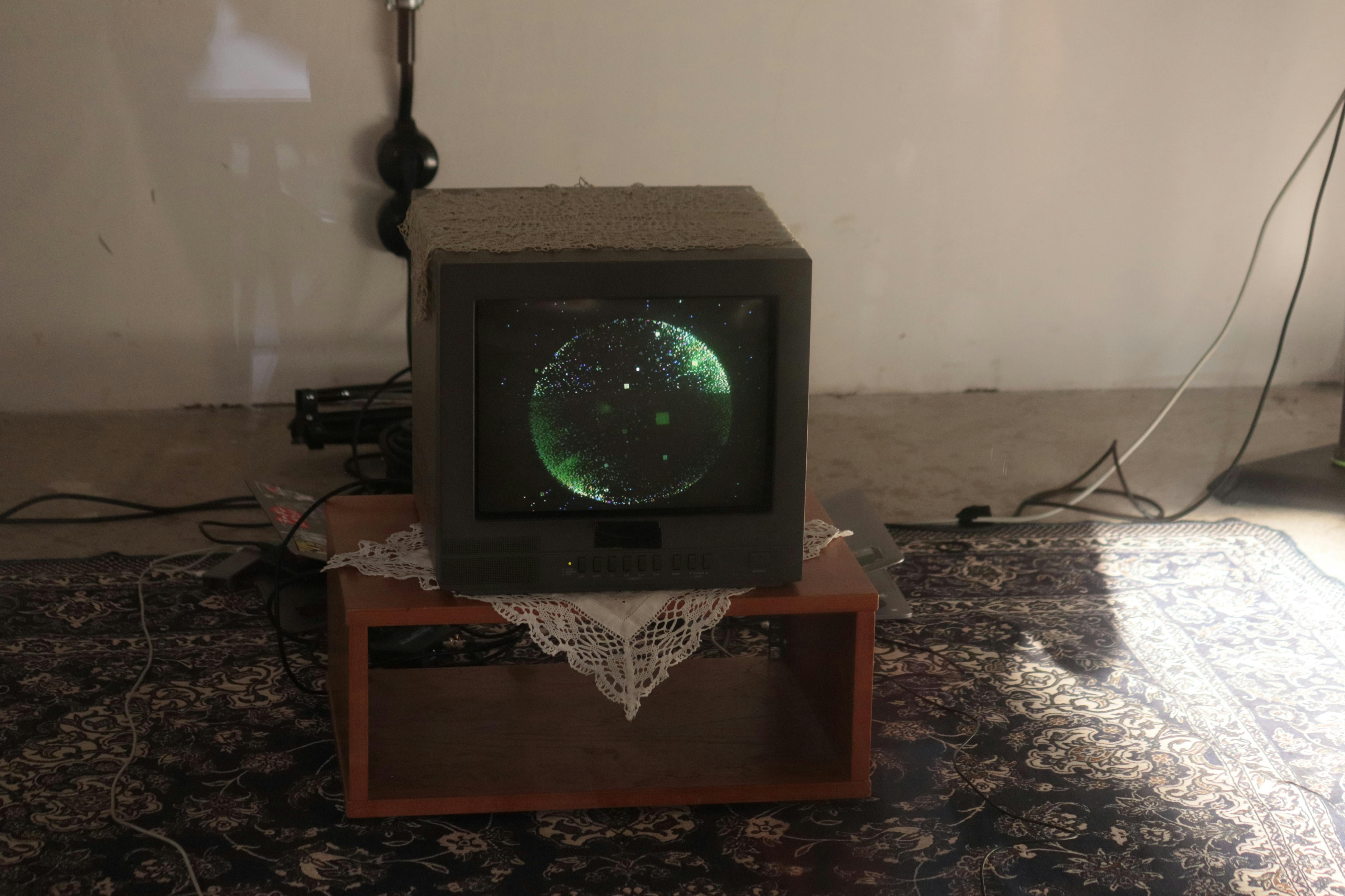 Digital art installation at the Catties featuring a CRT monitor displaying animated visuals