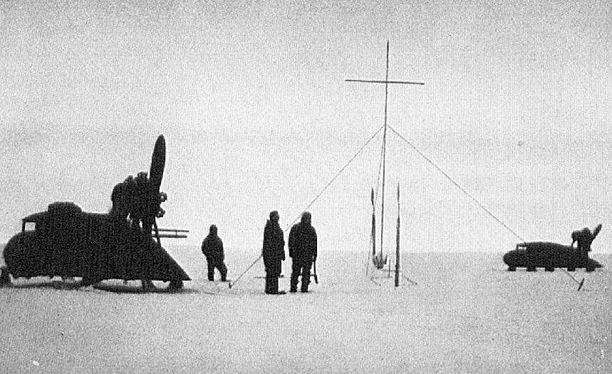 Propeller sleds and expedition members at the grave of Alfred Wegener