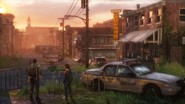 videogame screenshot of two figures infront of a deserted town at sunrise