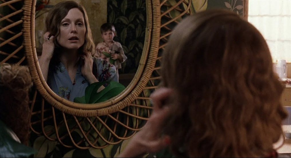 Nicole Kidman gets ready infront fo the mirror, her young son is stood behind her and looking at her in the mirror