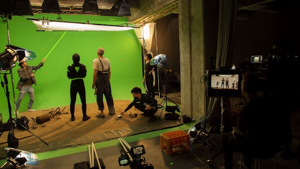 people infront of a green screen preparing for a scene