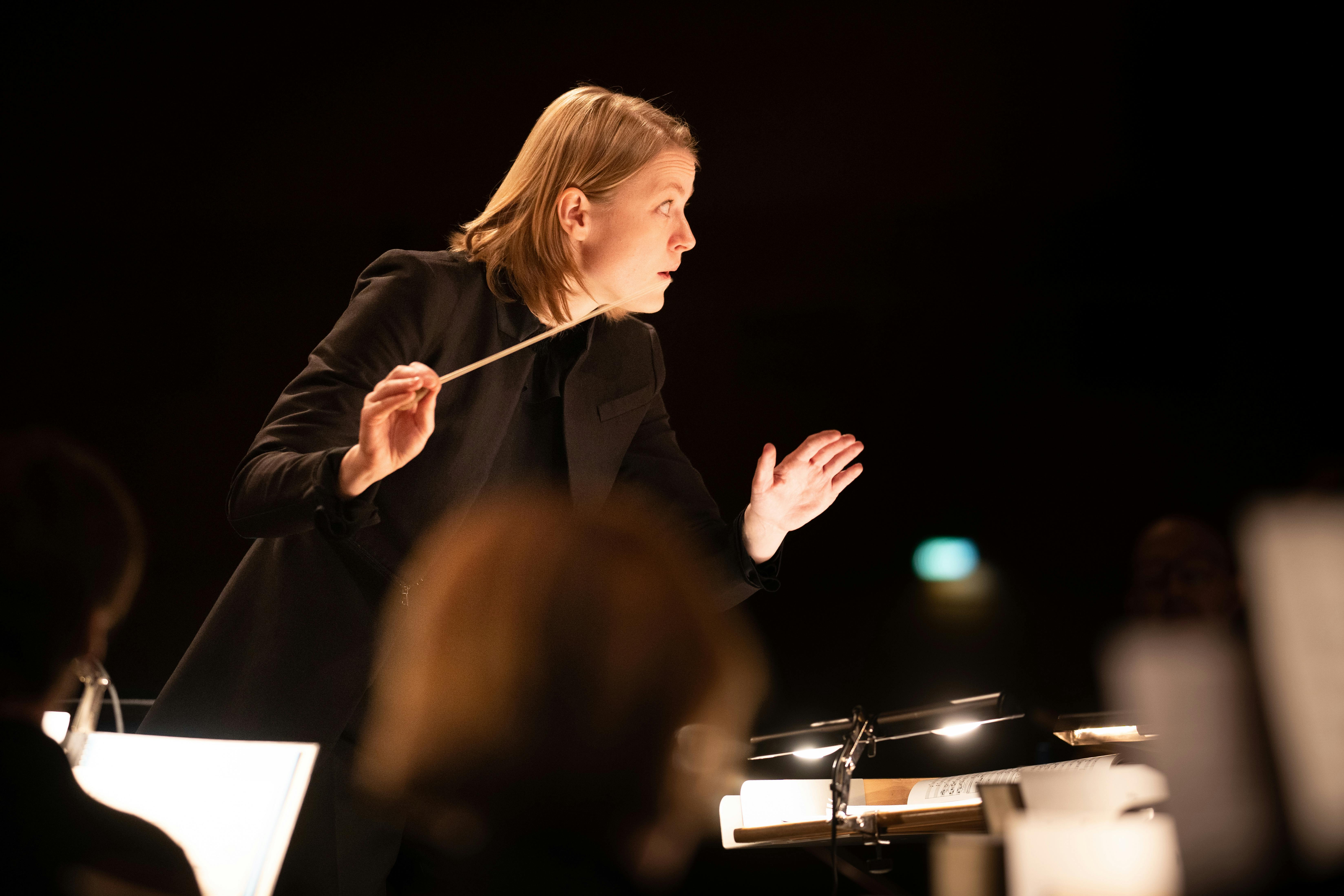 Conductor holds the gaze of one of her players