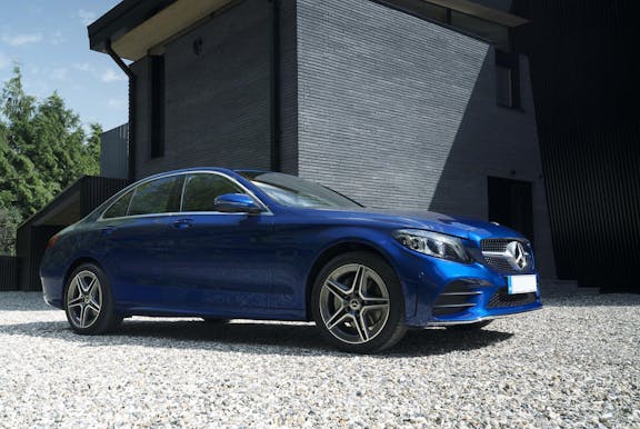 The side exterior of a blue Mercedes-Benz C-Class