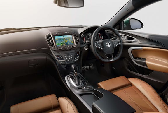 The interior of a Vauxhall Insignia with steering wheel and dashboard in shot