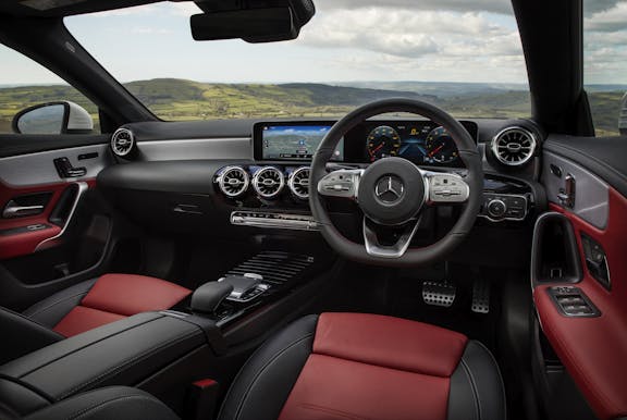 The interior of a Mercedes-Benz CLA with steering wheel and dashboard in shot