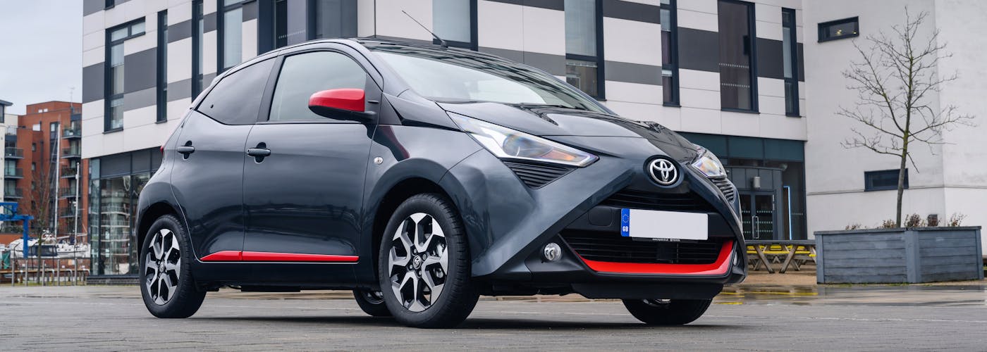 The front exterior of a black Toyota Aygo