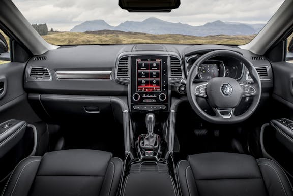 The interior of a Renault Koleos with steering wheel and dashboard in shot
