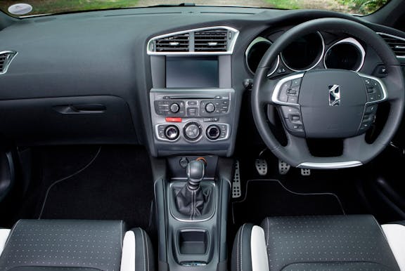 The interior of a Citroen DS4 with steering wheel and dashboard in shot
