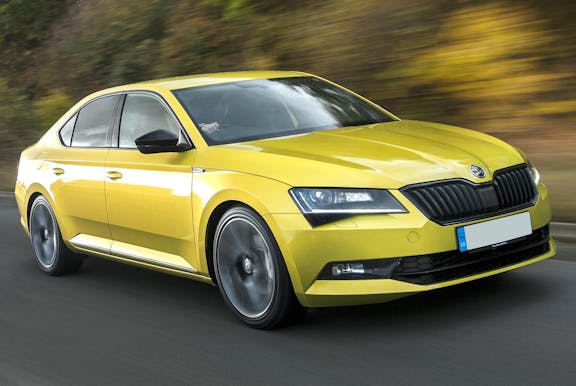 The front exterior of a yellow Skoda Superb