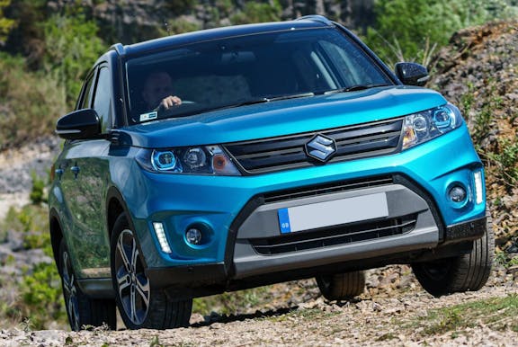 The front exterior of a blue Suzuki Vitara