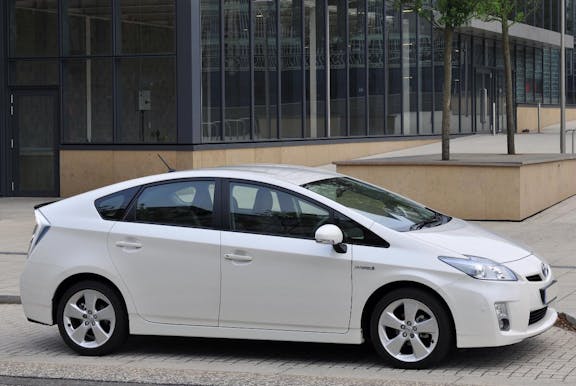 The side exterior of a white Toyota Prius
