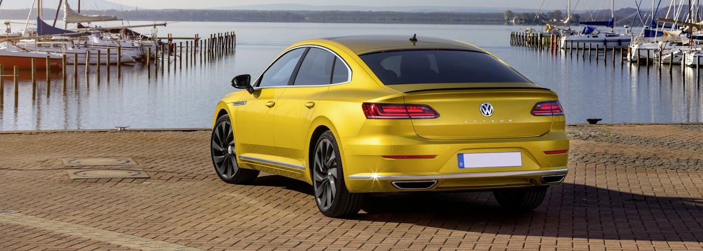 The rear exterior of a yellow Volkswagen Arteon