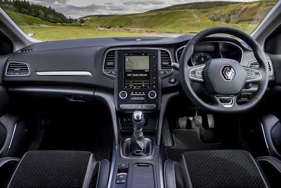 The interior of a Renault Megane with steering wheel and dashboard in shot