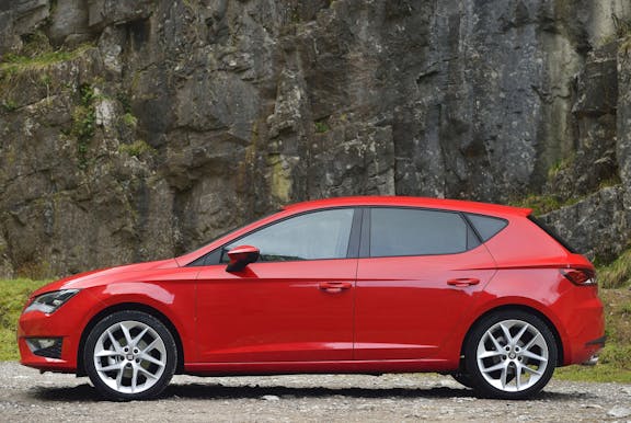 The side exterior of a red Seat Leon