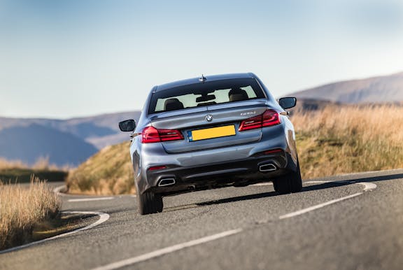 The rear exterior of a blue BMW 5 Series